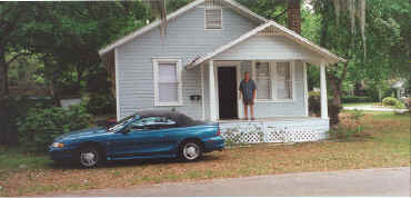 Photo:  Ray McNiece standing on the porch of the Kerouac House